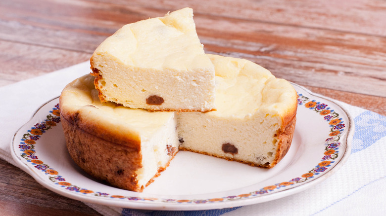 A Polish cheesecake sliced and stacked on a plate.