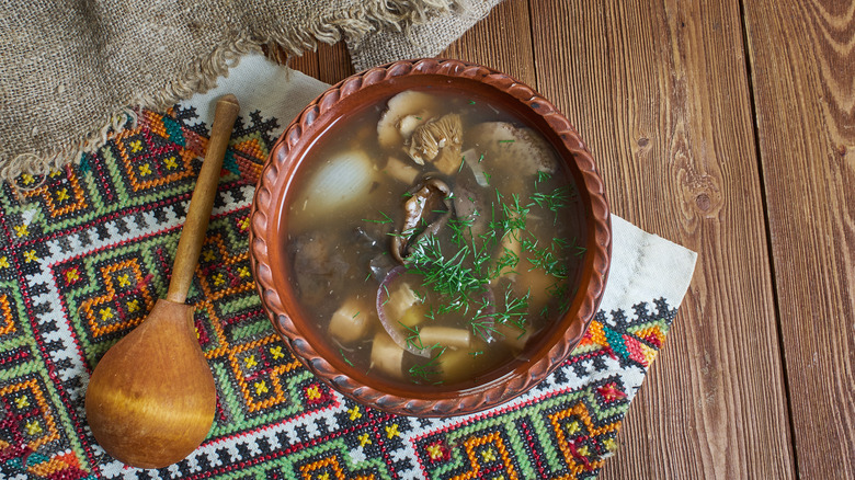 Zupa gryzbowa with wild mushrooms, garnished with dill.