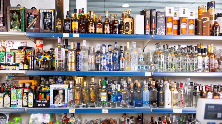 A shelf filled with different kinds of vodka bottles