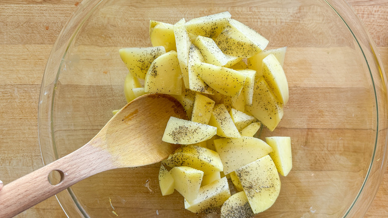 potatoes in bowl with seasonings