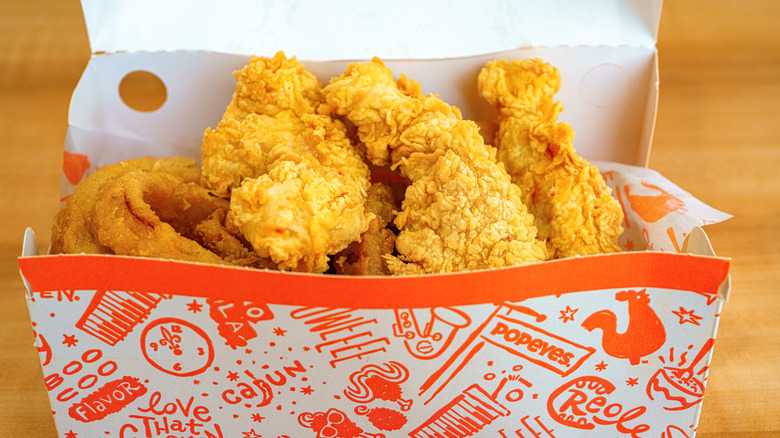 A Popeyes takeaway box with chicken tenders