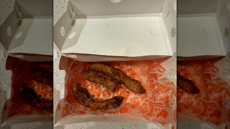 A three-piece portion of blackened chicken tenders from Popeye's restaurant