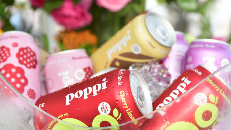 Bowl of Poppi soda cans in different flavors