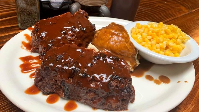 Big Al's barbecue plate with meat, corn, and potatoes