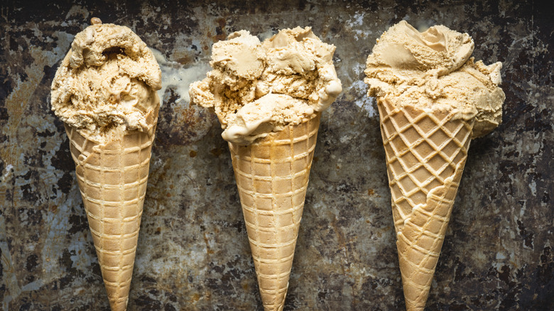 Three cones of salted caramel ice cream cones
