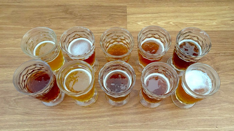 Ten glasses of different types of Oktoberfest beer lined up in two rows
