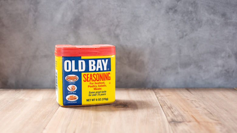 Box of Old Bay seasoning on a wooden surface