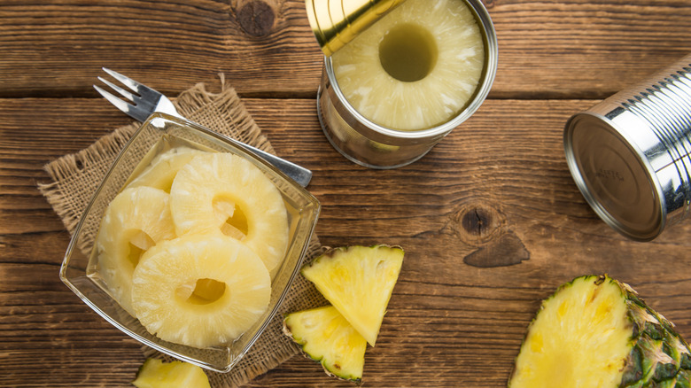 canned pineapple and pineapple in a bowl on the table