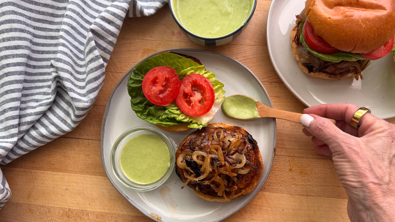 Open faced portobello mushroom burger and green sauce on plate