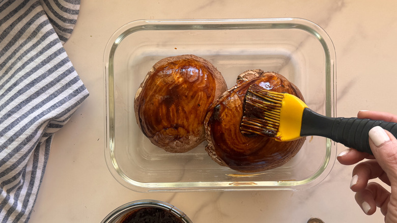 hand brushing caps with marinade