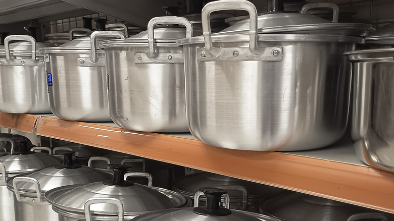 Neatly arranged cooking pots in a row.