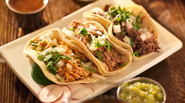 Mexican barbacoa served in soft taco shells.