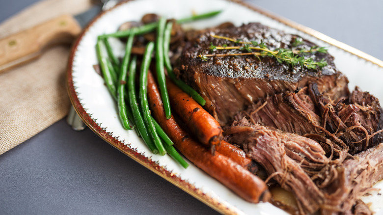 Pot roast served on a white oval platter