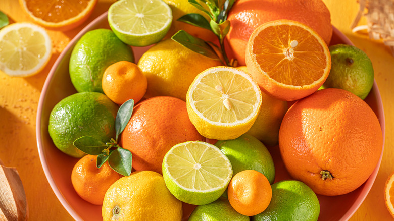 Bowl full of oranges, lemons, tangerines, and limes.
