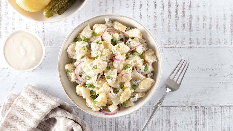 Potato salad in a bowl against a light background