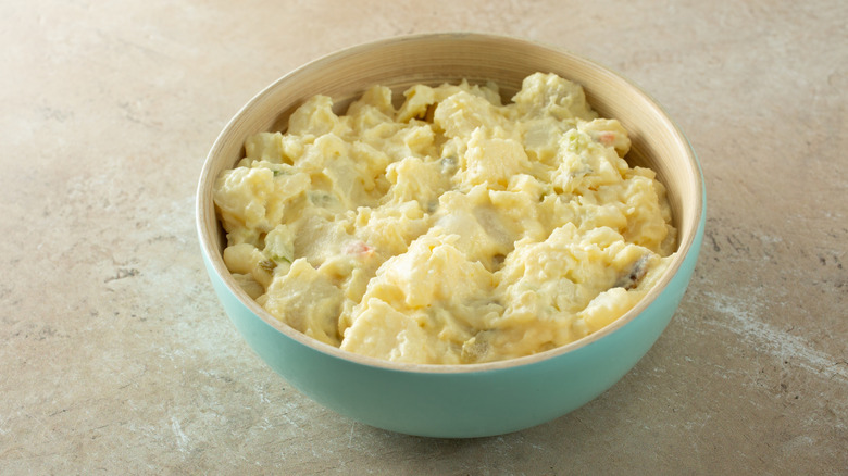 A bowl of potato salad on a tabletop