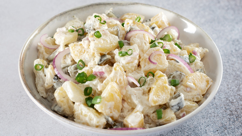Potato salad with pickles and onions.