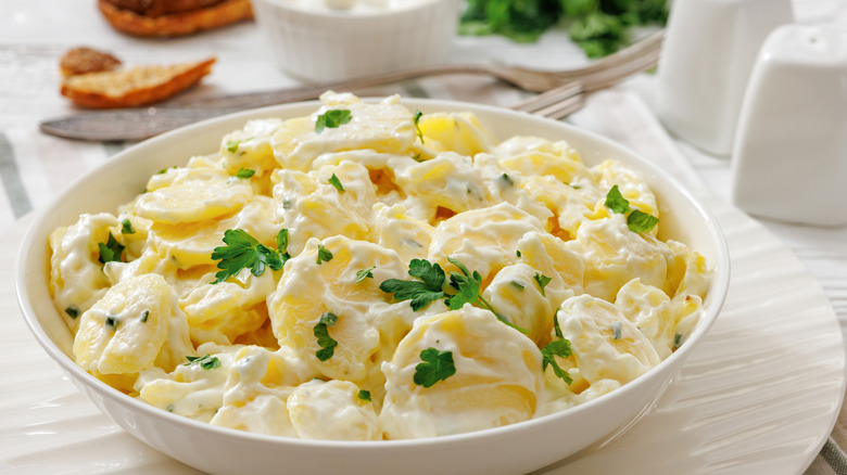 Mayo-based potato salad with fresh herbs on top