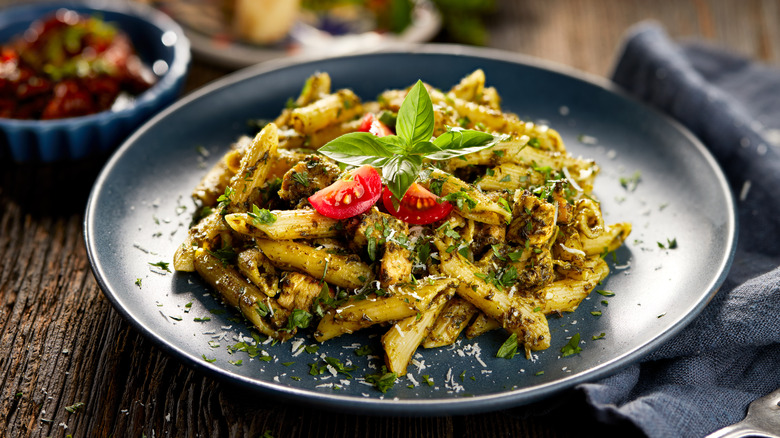 Plate of pesto penne with spinach and chicken