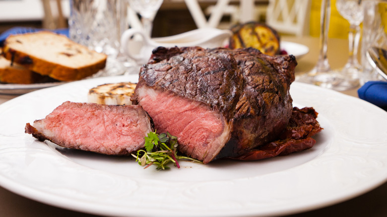 Rare-cooked sliced steak on a white plate