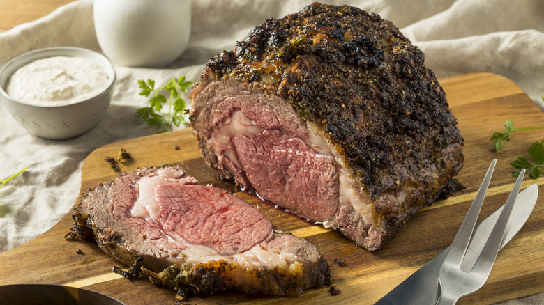 Prime rib sliced open on a cutting board.