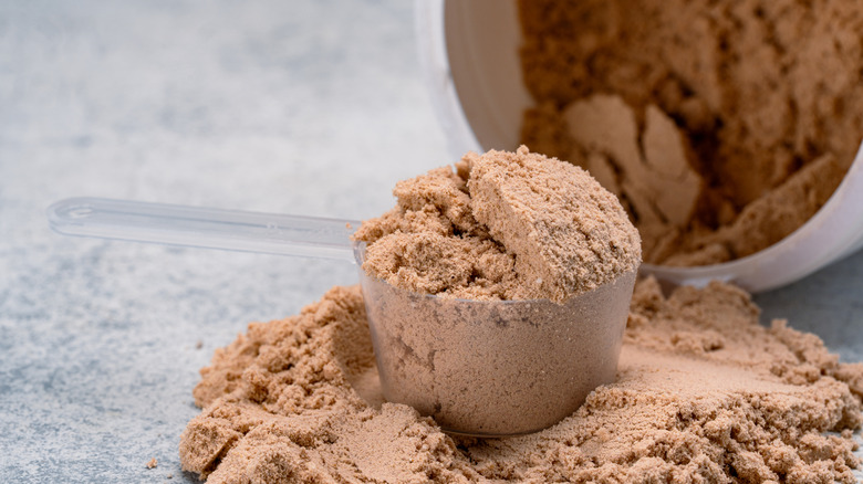 chocolate why protein powder in a plastic scoop