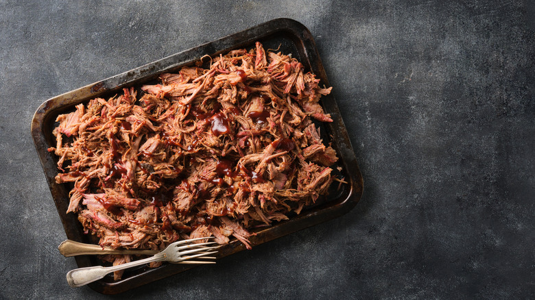 A container of pulled pork is photographed from above.