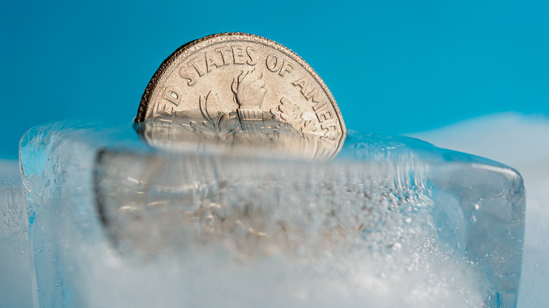 A coin frozen in a block of ice