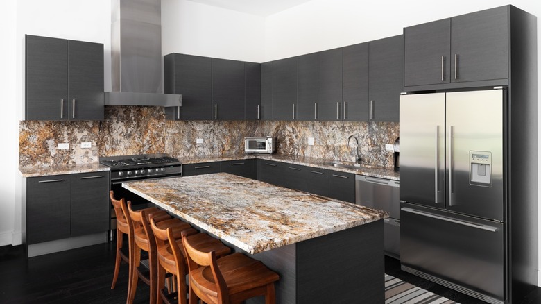 modern kitchen with brown granite countertops