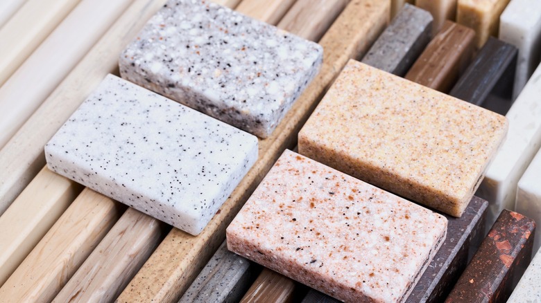 assorted sample slabs of quartz, granite, and marble for kitchen countertops