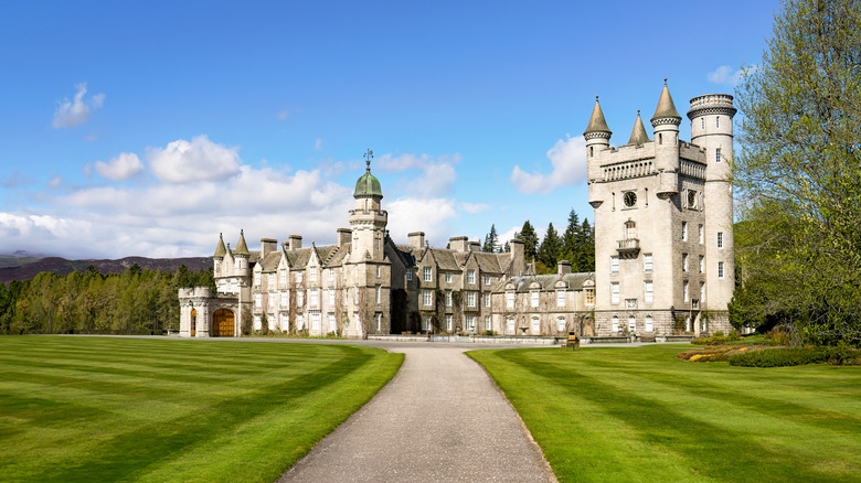 Balmoral Castle from afar, with sweeping green lawn