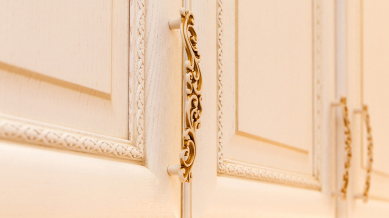 Ornate hardware on kitchen cabinets