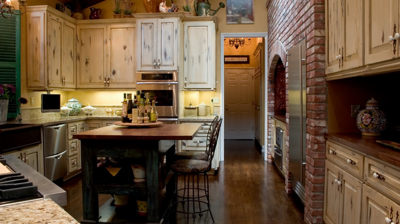 A kitchen with distressed cabinetry