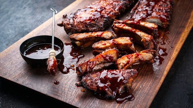 a bowl of barbecue sauce with ribs