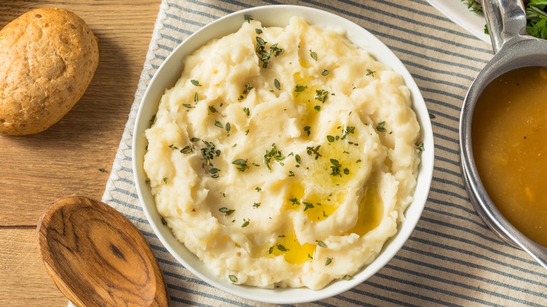 A bowl of mashed potatoes on a dining table