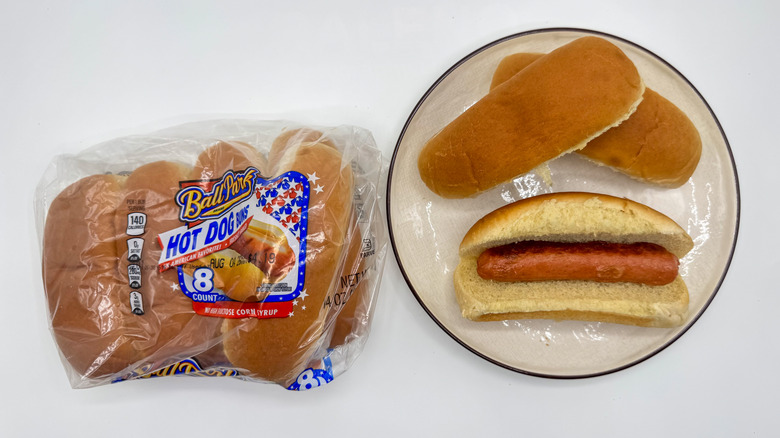 Hot dog with buns on a plate with packaging