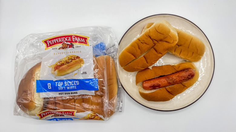 Hot dog with buns on a plate with packaging