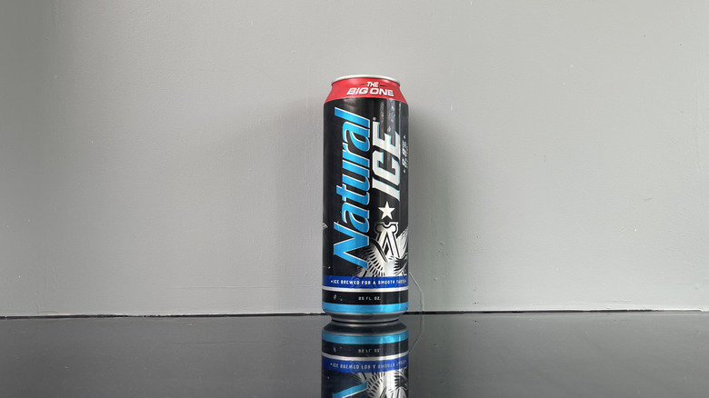 A tall boy of Natural Ice on dark table