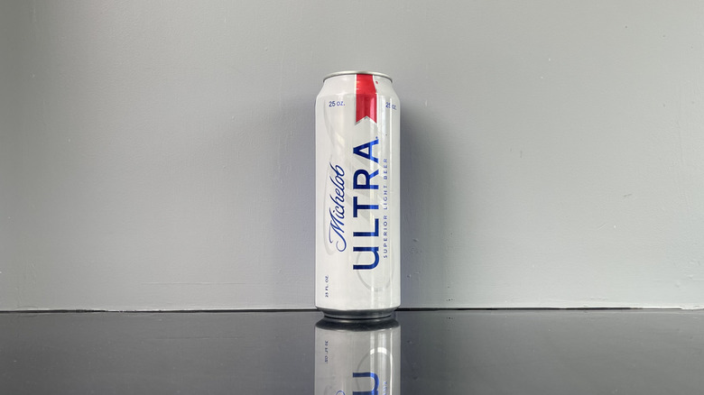 A tall boy of Michelob Ultra on dark table