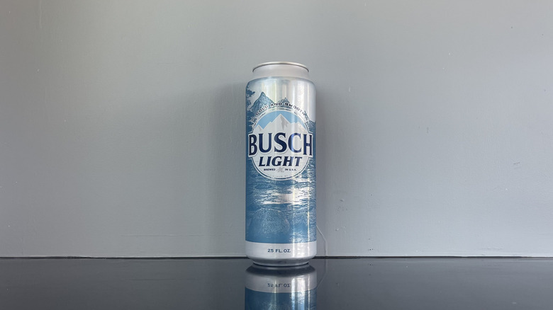 A tall boy of Busch light on dark table