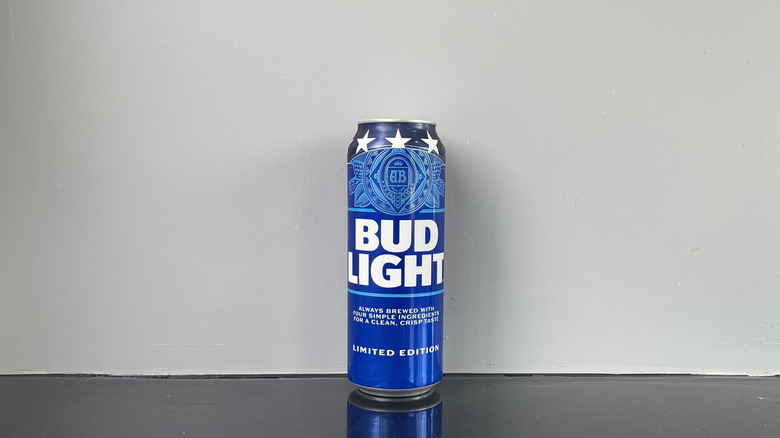 A tall boy of Bud light on dark table