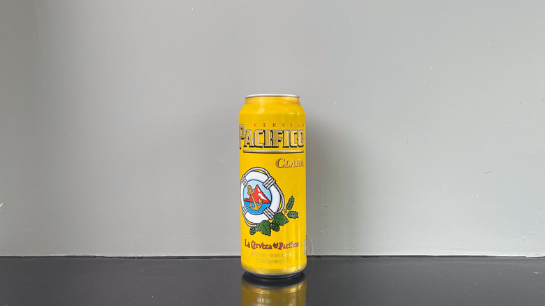 A tall boy of Pacifico on dark table