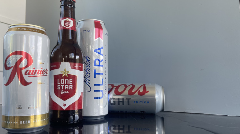 A Coors Light beer on the counter by 3 other beers