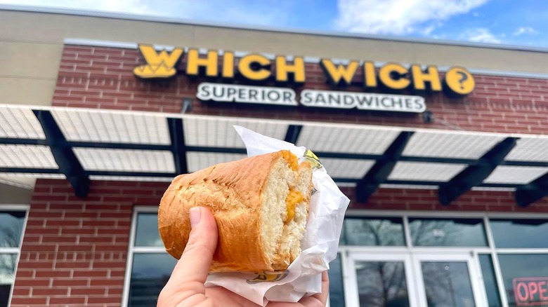 Hand holding Which Which's Grilled Cheese Kidswhich in front of store