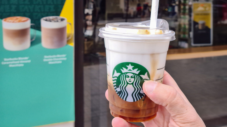 Hand holds a vanilla sweet cream cold brew