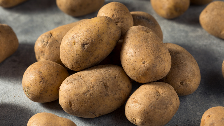 A group of Russet potatoes stacked on top of each other