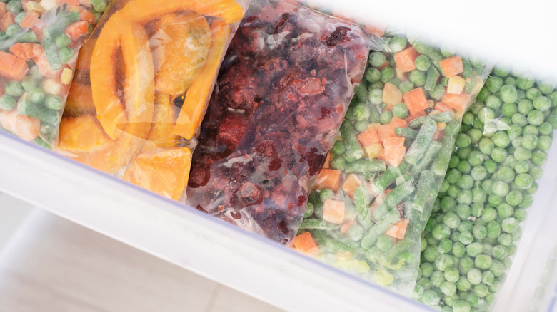 colorful frozen vegetables in freezer drawer top view