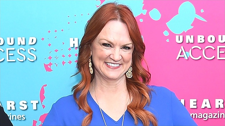 Ree Drummond smiling with teeth and wearing dangly earrings