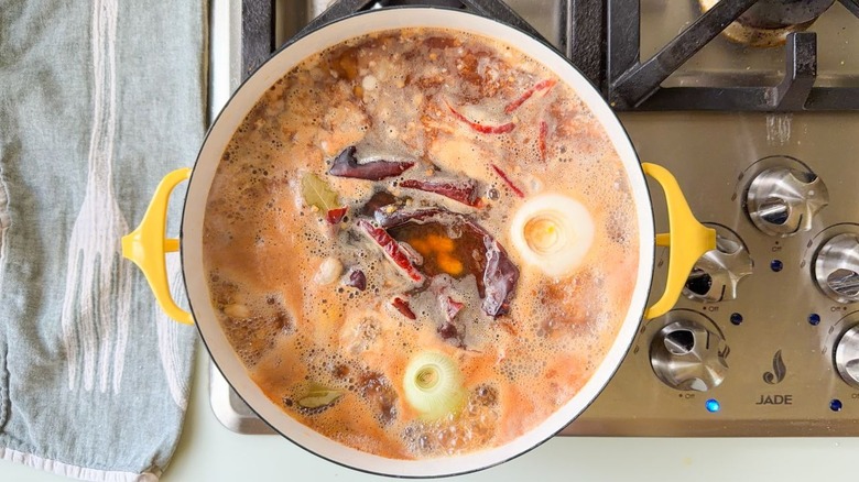 Mayocoba beans boiling in Dutch oven on stovetop