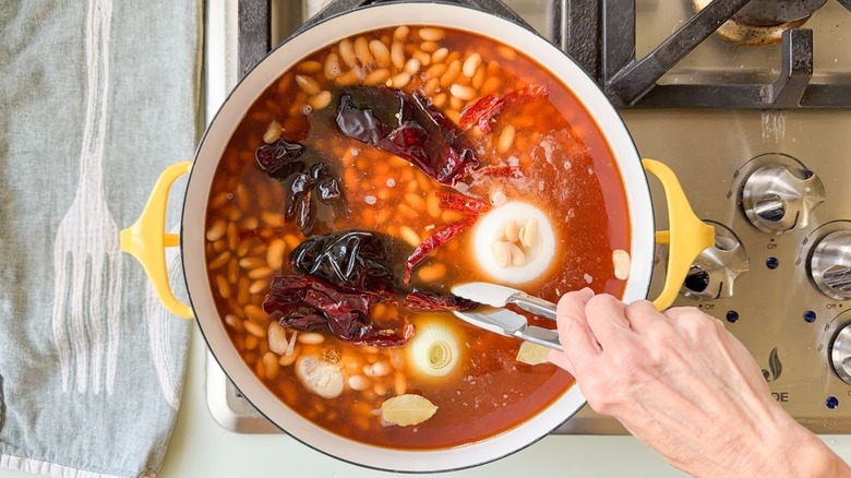 Dutch oven with Mayocoba beans dried chiles, garlic, and vegetable stock
